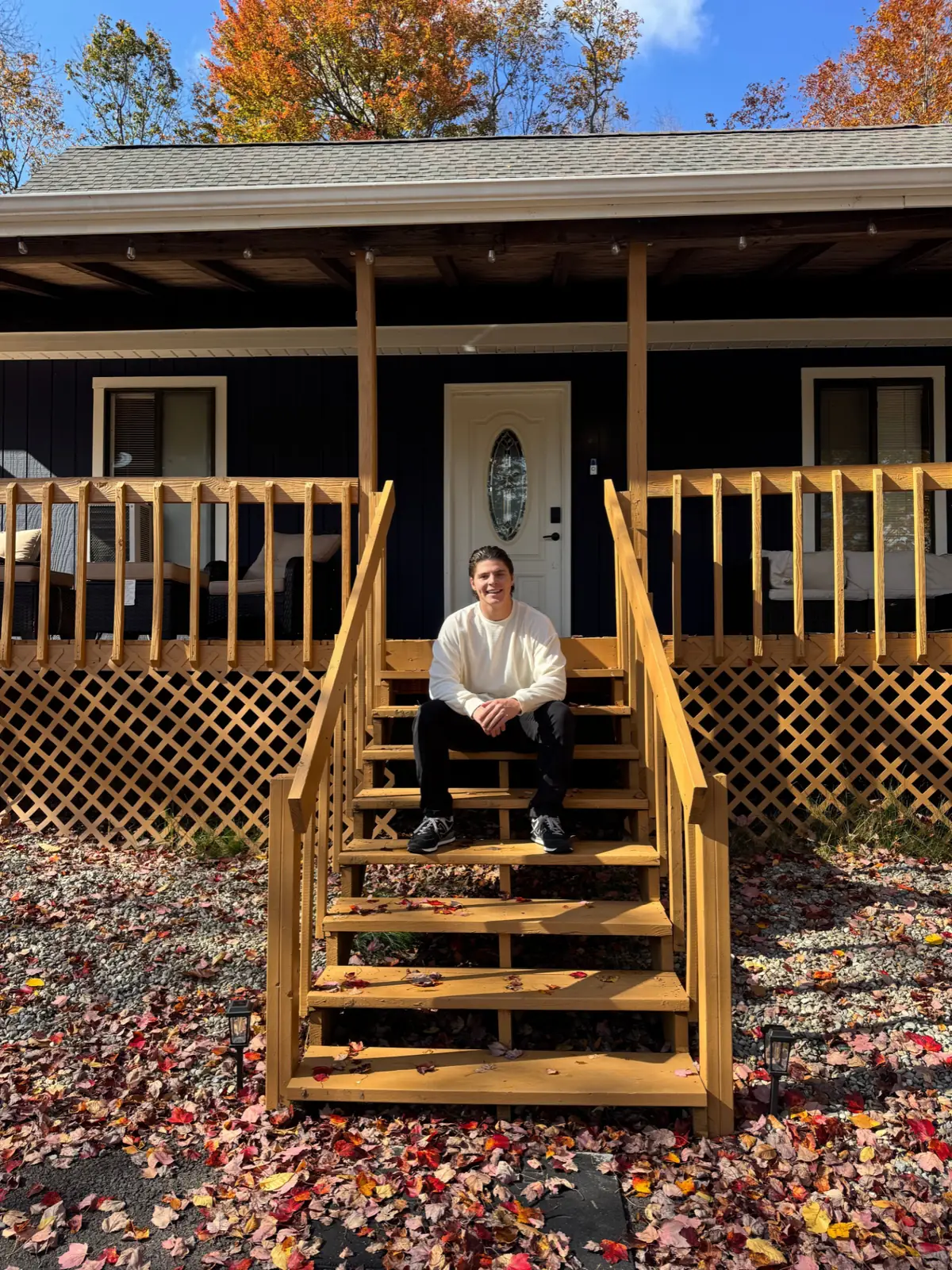 Dom Acevedo, Founder & CEO, sitting on the front steps of his home in the Poconos.